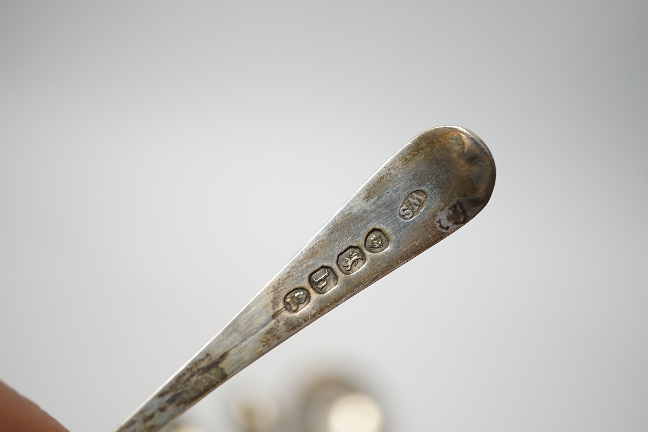 An 18th century silver mote spoon, marks rubbed, 11.8cm and five other various silver spoons and a pair of silver sugar tongs, 5.1oz.